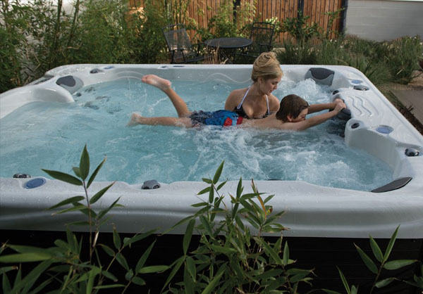 child swimming in swim tub with parental support